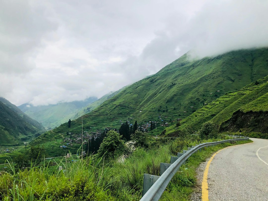 Winding mountain road through green terraced hillsides Winding mountain road through green terraced hillsides