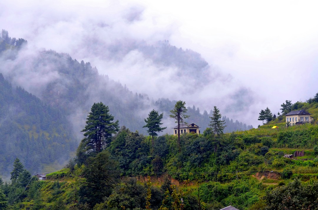 Green forested hills beneath clouds in Nepal Green forested hills beneath clouds in Nepal