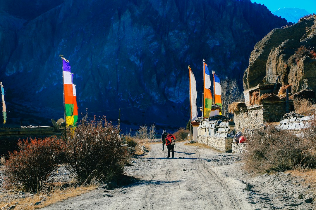 Trekkers walking a trail in the hills of Nepal Trekkers walking a trail in the hills of Nepal