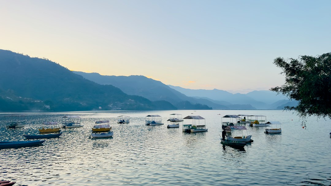 Colourful wooden boats on Phewa Lake in Pokhara, Nepal Colourful wooden boats on Phewa Lake in Pokhara, Nepal